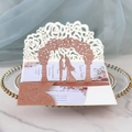 Macro detail of laser-cut rose gold glitter wedding invitation with 3D floral lace patterns - Glitter Champagne Gold