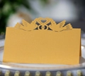 Detailed laser-cut wedding table card with hollow heart and dove design on golden paper - Gold