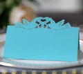 Close-up of laser-cut sky blue wedding place card with lovebirds and heart detail - Tiffany Blue