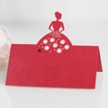 Macro detail of red laser-cut butterfly place card with elegant floral hollow patterns - Pearlescent Red