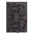 Macro view of black laser-cut invitation cover with intricate scroll and floral patterns - Black Khaki