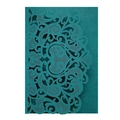 Macro detail of laser-cut damask patterns on teal European wedding invitation cover - Dark Green
