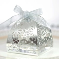 Detailed silver laser-cut wedding favor box with intricate floral patterns and blue ribbon - Double-Sided Reflective Silver