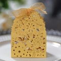 Detail of laser-cut hollow pattern and gold ribbon on European wedding candy gift box - Gold
