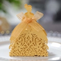 Close-up of laser-cut wedding candy box with golden female silhouette and ribbon bow - Gold