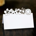 Elegant white laser-cut floral place cards for wedding and banquet table settings - White