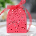 Macro view of laser-cut floral pattern and silk ribbon on red hollow candy box - Pearlescent Red