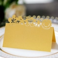 Elegant gold laser-cut sunflower table place card on a white porcelain dinner plate - Gold