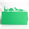 Detail view of laser-cut green cardstock featuring four distinct dinosaur silhouettes - Dark Green