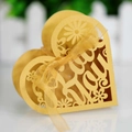 Macro shot of gold heart-shaped laser-cut gift box with Thank You cutout and ribbon - Gold