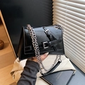 Chic black faux leather crossbody bag with silver chain strap and buckle detail - Black