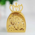 Close-up of laser-cut crown favor box with intricate floral hollow patterns in bright yellow - Gold