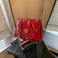Fashionable red glossy leather crossbody bag with silver chains and buckle straps - Red