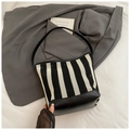 Black and white striped hollow knit bucket bag with sleek black leather shoulder straps - Black Small
