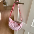 Detailed close-up of pink checkered canvas hobo bag with adjustable striped strap - Pink