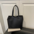 Minimalist black leather tote bag with long straps in a spacious design for women - Black