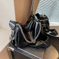 Y2K style black glossy shoulder bag with silver eyelets and chain strap detail - Black