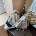 Silver metallic crossbody pillow bag with chain detail and eyelet strap in modern style - Silver