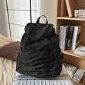 Lightweight black ruched nylon drawstring backpack on a suitcase for casual travel - Black