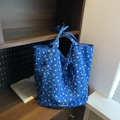 Blue quilted tote bag with pink floral patterns and a decorative front bow tie - Blue