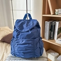 Casual blue nylon drawstring backpack with pleated texture on a silver suitcase - Blue