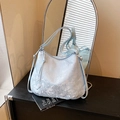 Light blue embroidered tote bag with silver floral patterns and drawstring closure - Blue