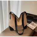 Close-up of beige canvas tote bag with black strap and matte gold metal hardware - Off-white