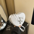 White heart-shaped crossbody bag with dual silver zippers and delicate metal chain strap - White