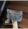 Close-up of vintage blue denim bag with multiple zipper pockets and adjustable silver buckle - Blue