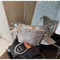 Detail of silver metallic handbag with pleated texture and pearl bow charm accessory - With Charm / Silver