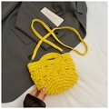 Detail of yellow hand-crocheted bucket bag featuring thick knit texture and braided straps - Yellow