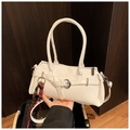 Detail of cream white leather shoulder bag with buckle strap and woven rope charm - With Pendant Style / White