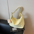 Pale yellow crossbody dumpling bag with embroidery and plush bear charm accessory - Yellow with Pendant