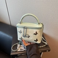 Fashionable mint green vanity bag with silver butterfly charms and metal handle - Green