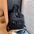 Black nylon multi-functional backpack with flap pocket and adjustable straps in sunlight - Black