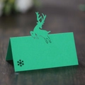 Green kraft paper place card featuring a laser-cut reindeer and snowflake for Christmas tables - Dark Green