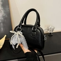 Black lychee leather Boston bag featuring white lace bow and pearl charm ornament - Black
