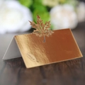 Detail of laser-cut golden maple leaf place card with metallic hollow engraving - Reflective Gold