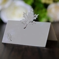 Close-up of laser-cut place card with maple leaf hollow design and pearlescent finish - Reflective Silver
