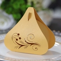 Close-up of golden tulip hollow candy box on a white porcelain plate for wedding favors - Gold