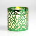 Green cut-out metal candle holder with rose patterns and lit tea light inside - Double-Sided Reflective Green