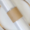 Modern white fabric napkin with minimalist brown paper band on gold floral white plate - Kraft Paper