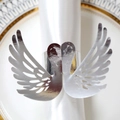 Close-up of elegant silver swan napkin ring with hollow wings for table decor - Reflective Silver