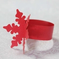 Macro detail of red paper napkin ring featuring delicate laser-cut snowflake patterns - Pearlescent Red
