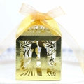 Detail of laser-cut gold wedding favor box with bride and groom silhouette and ribbon - Double Sided Reflective Gold