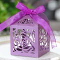 Macro view of purple laser-cut rose gift box with pearlescent texture and ribbon bow - Dark Purple