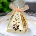 Detailed view of pyramid candy box with snowflake cutouts and champagne ribbon bow - Reflective Gold