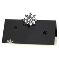 Macro view of black laser-cut snowflake place card with elegant hollowed-out patterns - Black