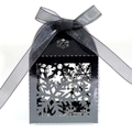 Detail of black hollow snowflake candy box featuring a matching satin ribbon bow - Black