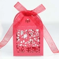 Close-up of red laser-cut snowflake candy box with elegant organza ribbon bow - Pearlescent Red